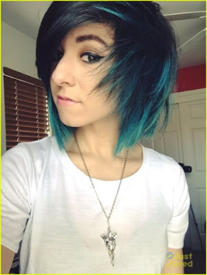 Christina Grimmie in an all too familiar 'all seeing eye' pose ala blue hair and the elven Evenstar necklace from Lord of the Rings, a symbol of immortality.