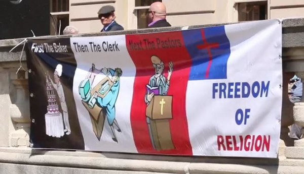 Banner at Free Kim Davis Rally Sept 8, 2015: "First the Baker, then the Clerk, next the Pastors"